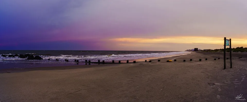 Beach at dusk with a wooden groyne and pastel sky