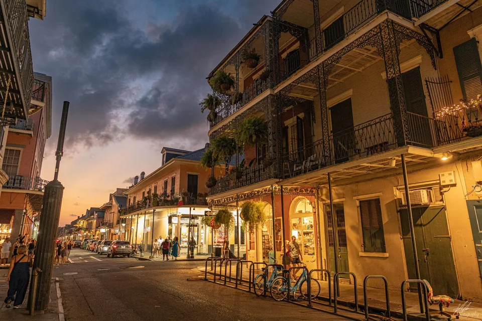 Street with iron balconies glowing at dusk