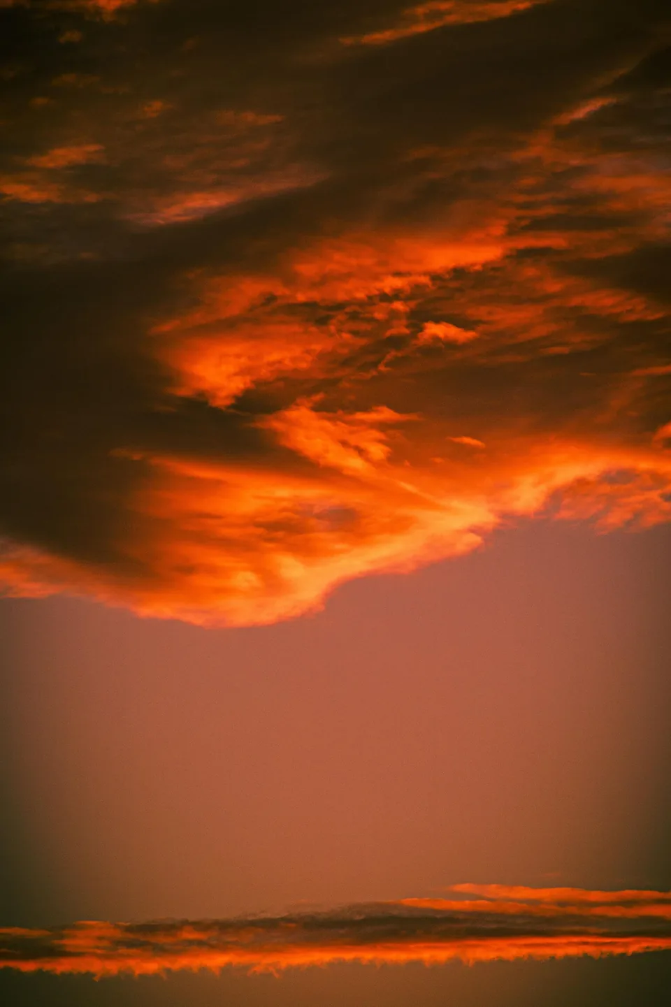 Fiery red clouds over a desert horizon