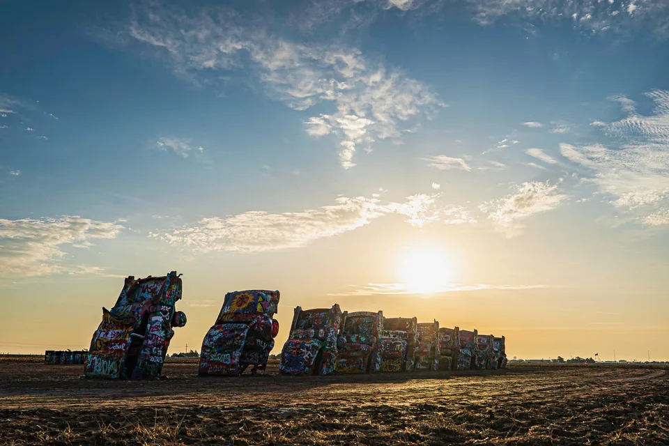 Graffiti-covered cars of Cadillac Ranch at sunset