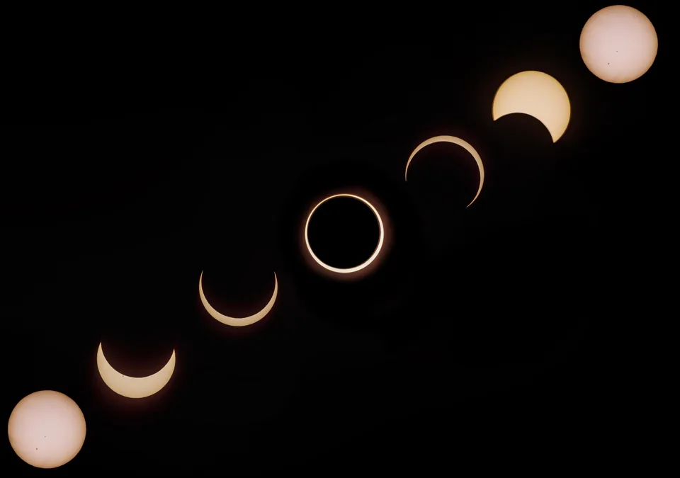 Sequence of a solar eclipse arcing across a black sky
