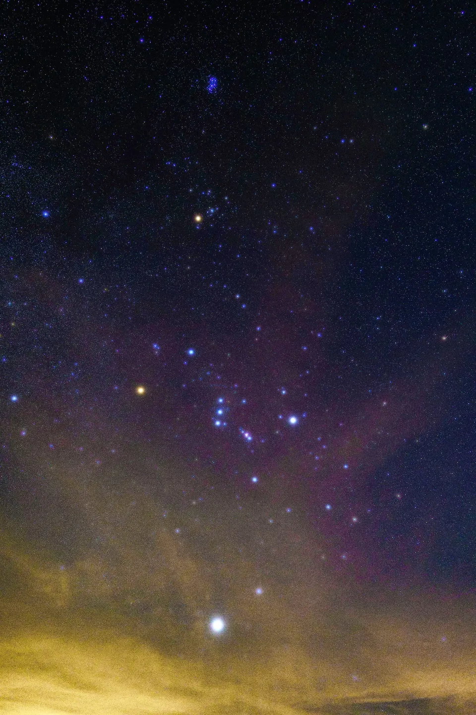 Orion rising above a glowing horizon